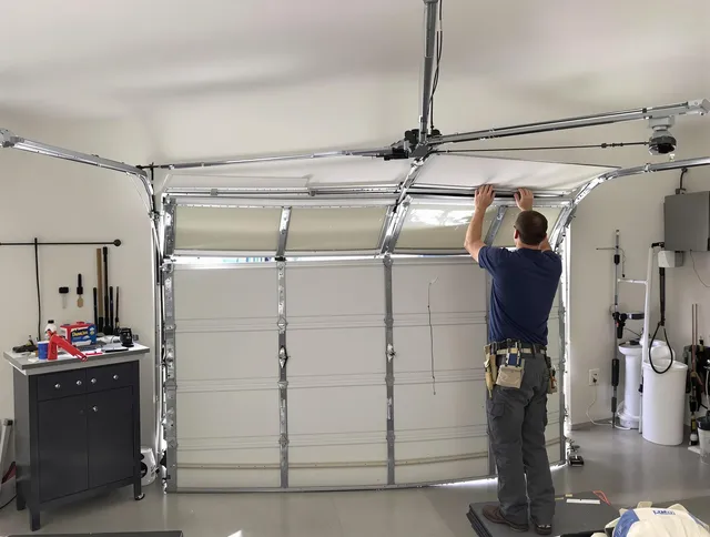 Acushnet Garage Door Repair specialist performing precise section replacement on Acushnet garage door